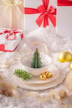 Snowy white table setting with festive trimmings. Stock Photos