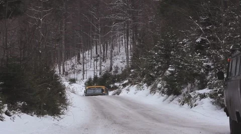 Snowy winding road in a mountainous area. Car transports tourists to the top of  Stock Footage 59159126
