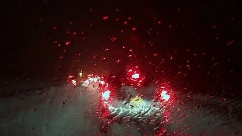 Snowy Windshield During Nighttime Winter Traffic Jam Stock Footage 98415866