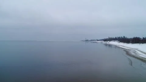 Snowy Winter Beach Horizon - Drone Gliding Parallel to the Baltic Coastline, 4K Stock Footage 295106944