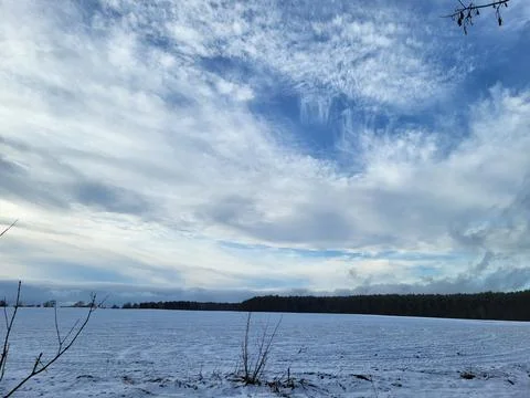 Snowy Winter Field under Dramatic Sky Stock Photos