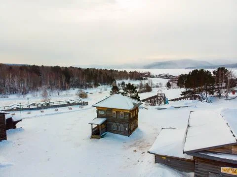 A Snowy Winter Landscape Featuring Rustic Buildings Nestled Amidst Stock Photos