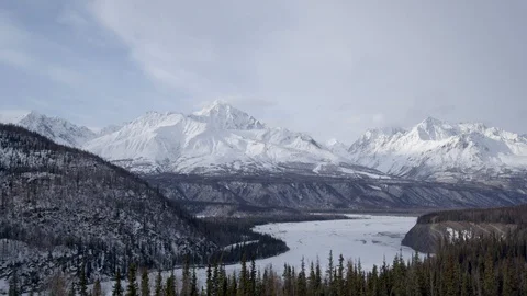 Snowy winter mountain panorama view with tree forest and frozen lake Stock Footage 121575775