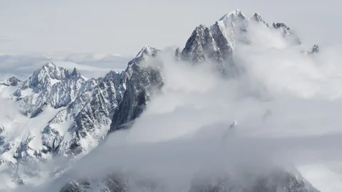 Snowy winter mountains with cloudy sky background in foggy weather Stock Footage 121575231