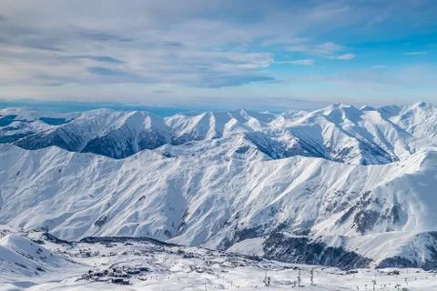 Snowy winter mountains in sun day. Caucasus Mountains, Georgia, from ski resort Stock Photos