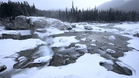 Snowy winter river waterfall in snowstorm Video stock 85495366