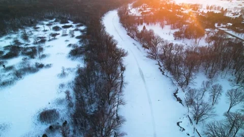 Snowy Winter Sunset Circular Drone Video Above a River Stock Footage 229655548