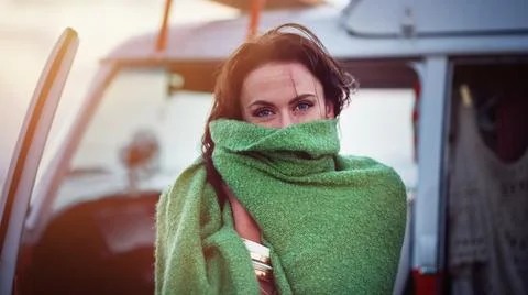 Snug as a bug in a rug. Portrait of an attractive young woman wrapped in a Stock Photos
