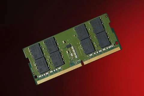 SO-DIMM DDR5 RAM module for laptop upgrades, isolated on a red background. Stock Photos