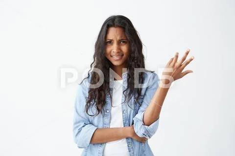 So what. Clueless puzzled Afro-American woman gesturing with hands in ignorance Stock Photos