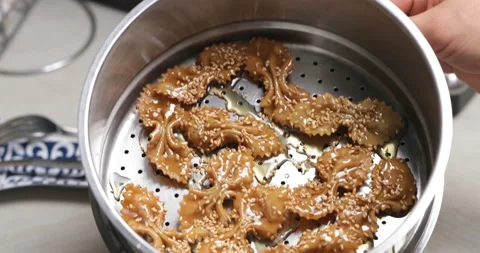 Soaking chebakia in syrup Stock Footage 236539706