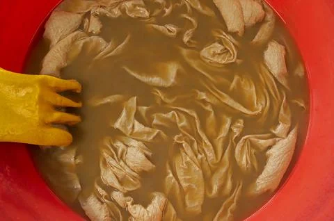 Soaking cloth in dye process for saree printing, India Stock Photos
