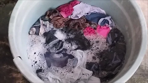 Soaking clothes with washing soap Stock Footage 297027269