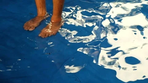 Soaking feet in blue plastic pool Stock Footage 277496956