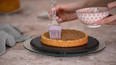 Soaking a Sponge Cake Layer with Coffee. Stock Footage 168989831