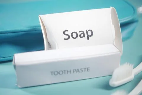 Soap and toothpaste packaging displayed on a colorful background Stock Photos