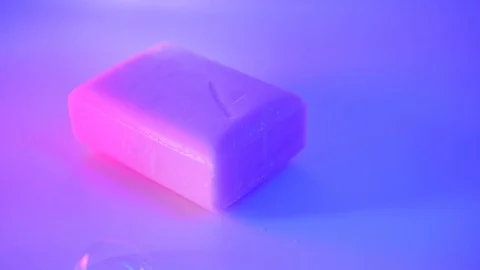 Soap bar and bubbles colorfully lit Video stock 127514581