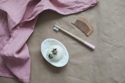 Soap bar or solid shampoo on a soap dish, bamboo toothbrush and towel top view 스톡 사진