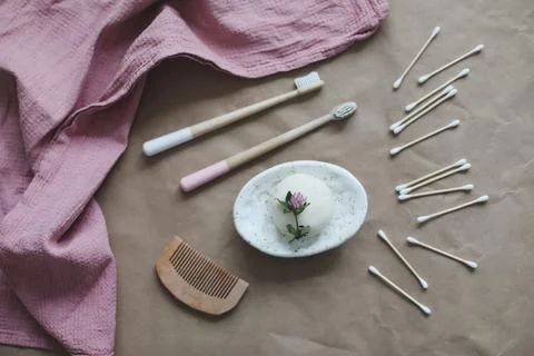 Soap bar or solid shampoo on a soap dish, bamboo toothbrush and towel top view Stock Photos