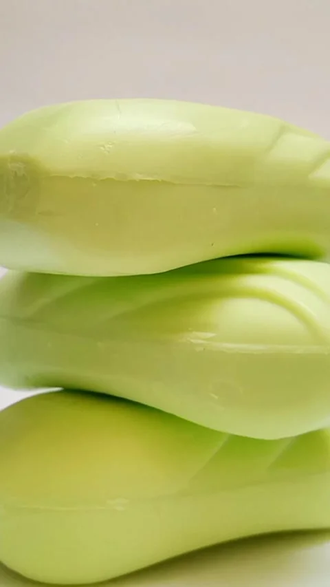 Soap bar. yellow soap bars tower for bath rotating on white background. Stock Footage 308510899
