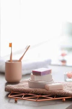 Soap bars and towel on table against blurred background. Space for text 스톡 사진