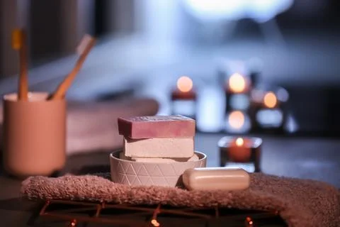 Soap bars and towel on table against blurred background. Space for text Foto stock