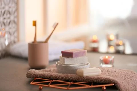 Soap bars and towel on table against blurred background. Space for text Foto stock