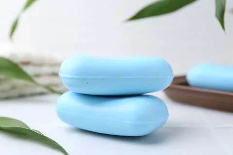 Soap bars with foam on white table, closeup 写真素材