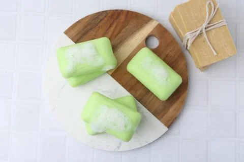 Soap bars with foam on white table, top view Stockfoto's