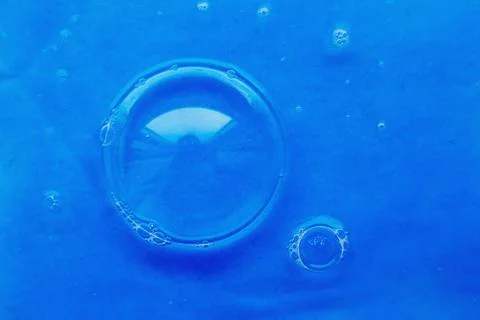 Soap bubble close up. abstract blue water background Фото