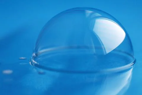 Soap bubble close up. abstract blue water background Фото