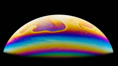 Soap bubble. Close-up. Black background. Bright colors. Stock Photos