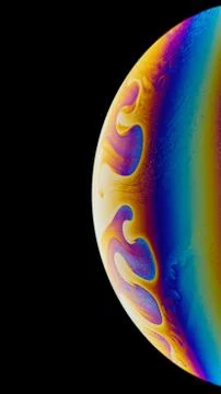 Soap bubble. Close-up. Bright colors. Imitation of an unknown planet. Stock Photos