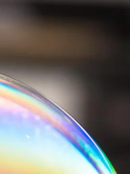 Soap bubble - colourful rainbow pattern on dark background - symbol of hope w Stock Photos