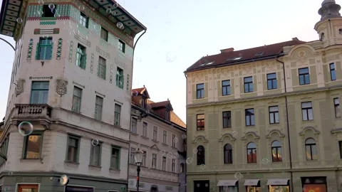 Soap bubble floats through historic street in Ljubljana Slovenia - Urban Avenue Stock Footage 339646179