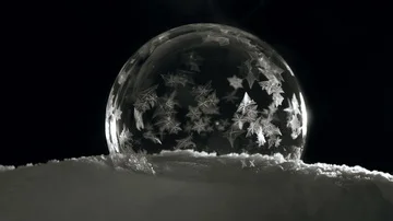 Soap bubble freezing on black bagground Stock Footage 85663827