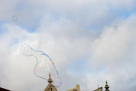 Soap bubble hovering in front of Lisbon waterfront architecture Foto stock