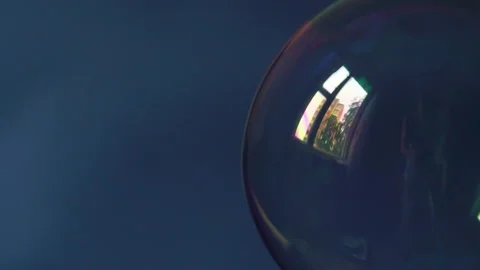 The soap bubble inflates and flies through the frame. On a dark background 動画素材 234142558