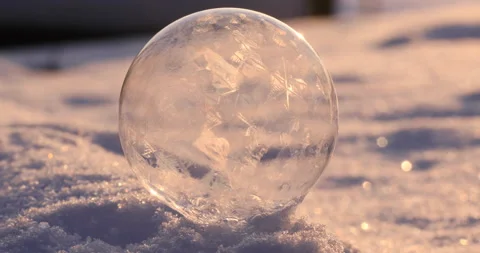 Soap bubble in the snow in winter. Ice patterns on the surface Stock Footage 163515722