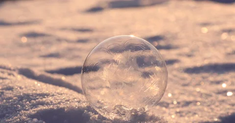 Soap bubble in the snow in winter. Ice patterns on the surface Video stock 163516166