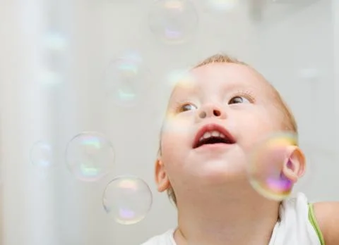 Soap bubbles and the boy Stock Photos