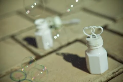 Soap bubbles and white container with hearts Stock-Fotos