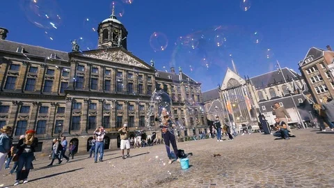 Soap bubbles artist Dam Square Amsterdam - slow motion Stock Footage 95991753