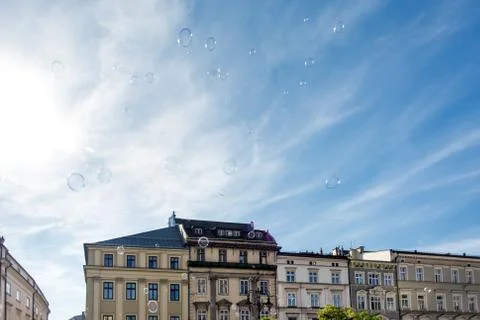 Soap bubbles on a background of blue sky and buildings Stock Photos