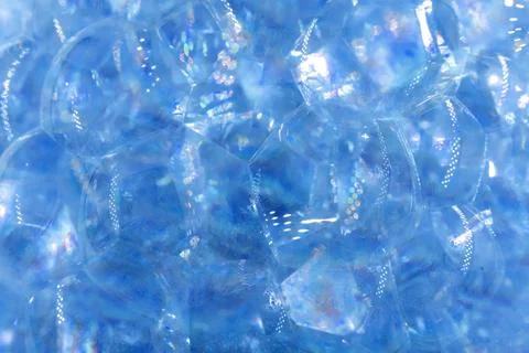 Soap bubbles background in blue. Soap or shampoo bubbles close-up Stock Photos