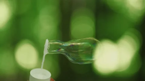 Soap bubbles on the background of the forest, the filming shows how the bubbl Stock Footage 154563555