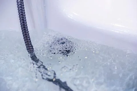 Soap bubbles background. Shampoo foam in the water in the bathroom. Jacuzzi.. Stock Photos