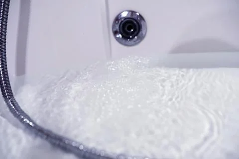 Soap bubbles background. Shampoo foam in the water in the bathroom. Jacuzzi.. Stock Photos
