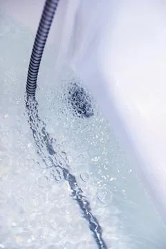 Soap bubbles background. Shampoo foam in the water in the bathroom. Jacuzzi.. Stock Photos