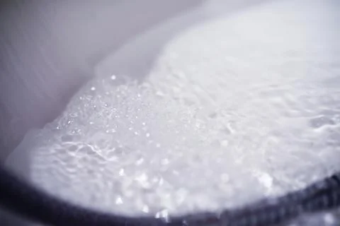 Soap bubbles background. Shampoo foam in the water in the bathroom. Jacuzzi.. Stock Photos